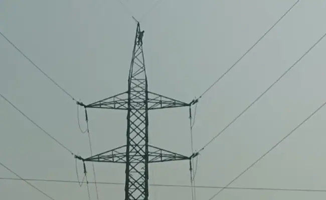 A video shows the man standing at the top of the electric pole.